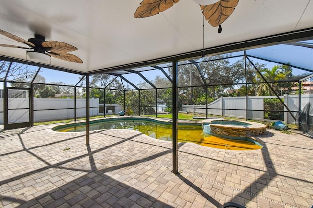 unfurnished sunroom with a pool, a jacuzzi, and ceiling fan
