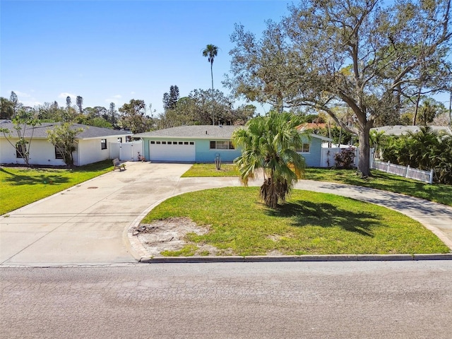view of front facade featuring curved driveway, stucco siding, fence, an attached garage, and a front lawn