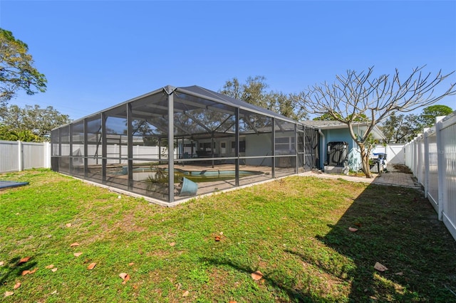 exterior space featuring glass enclosure, a fenced in pool, a fenced backyard, and a patio area