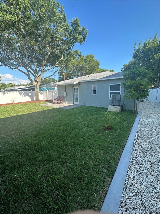 view of yard with a patio and a fenced backyard