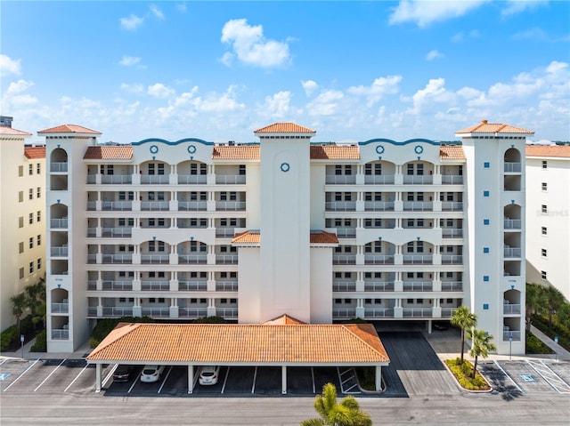 view of building exterior with uncovered parking