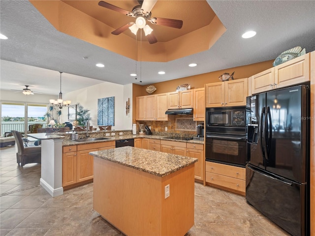 kitchen featuring a center island, a sink, a peninsula, and black appliances