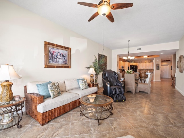 living area with visible vents, baseboards, and ceiling fan with notable chandelier