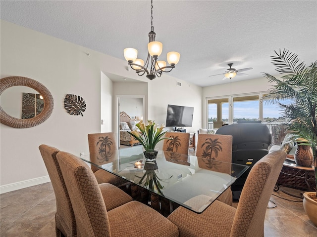 dining room featuring visible vents, baseboards, a textured ceiling, and ceiling fan with notable chandelier