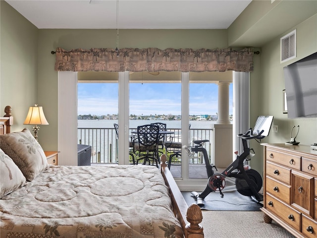 carpeted bedroom with access to exterior and visible vents