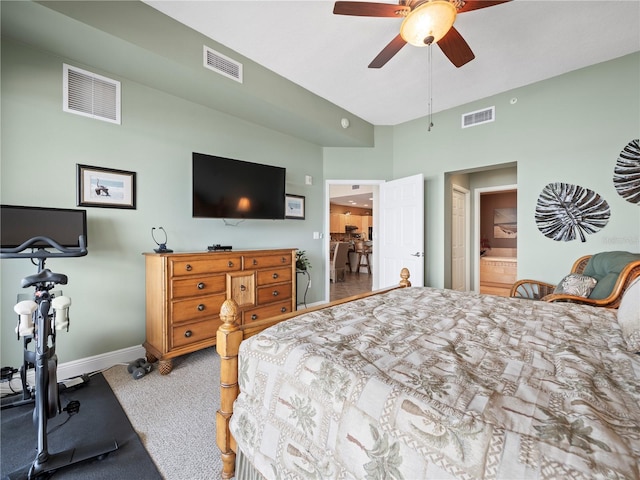 carpeted bedroom featuring visible vents, connected bathroom, and baseboards