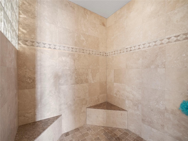 full bath featuring a tile shower