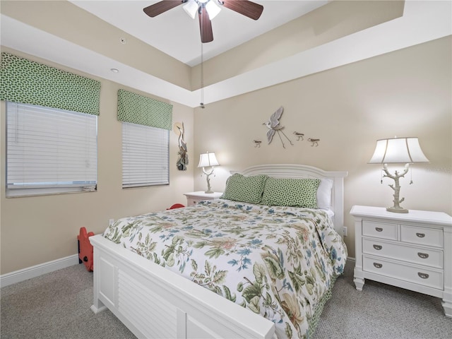 bedroom with baseboards, a ceiling fan, and light colored carpet