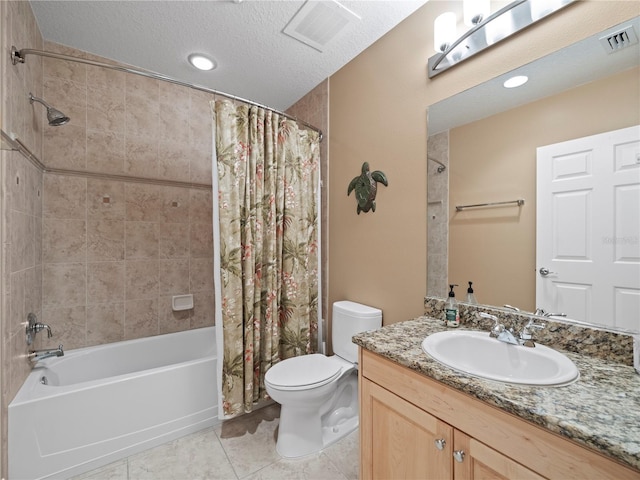 bathroom featuring visible vents, toilet, vanity, a textured ceiling, and tile patterned flooring