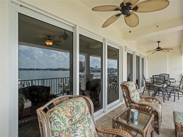 exterior space with a water view and outdoor dining space