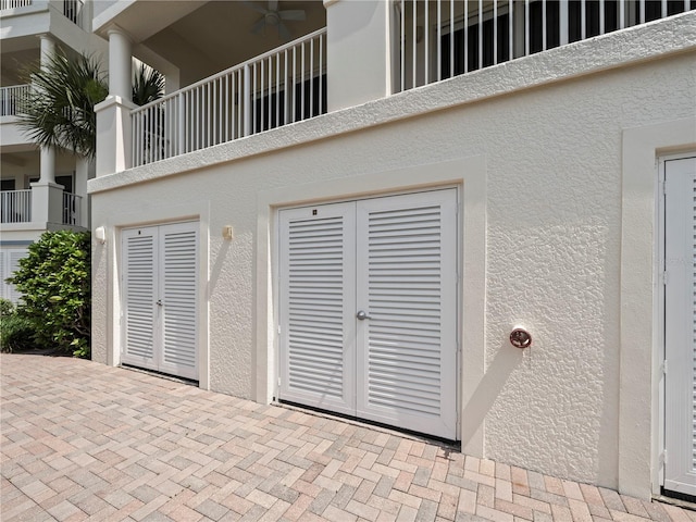 details featuring stucco siding, ceiling fan, and french doors