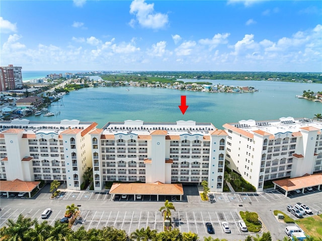 birds eye view of property with a water view and a city view