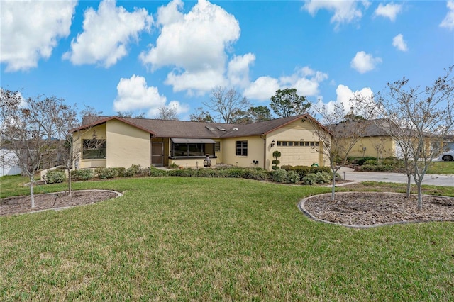 single story home featuring an attached garage, driveway, a front lawn, and stucco siding