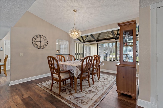 dining area featuring dark wood-style floors, vaulted ceiling, a textured ceiling, and baseboards