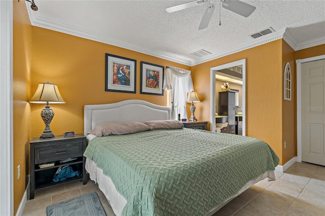 bedroom featuring a textured ceiling, ornamental molding, tile patterned flooring, and visible vents