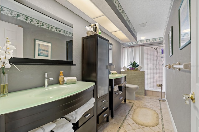 bathroom featuring a shower with curtain, toilet, a textured ceiling, vanity, and tile patterned flooring