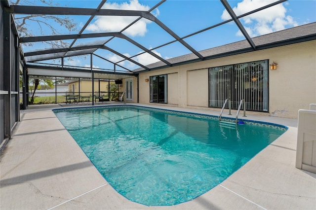 pool featuring a patio area and glass enclosure