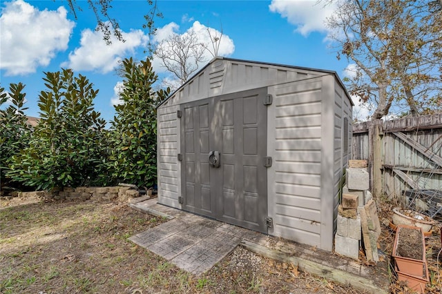 view of shed with fence