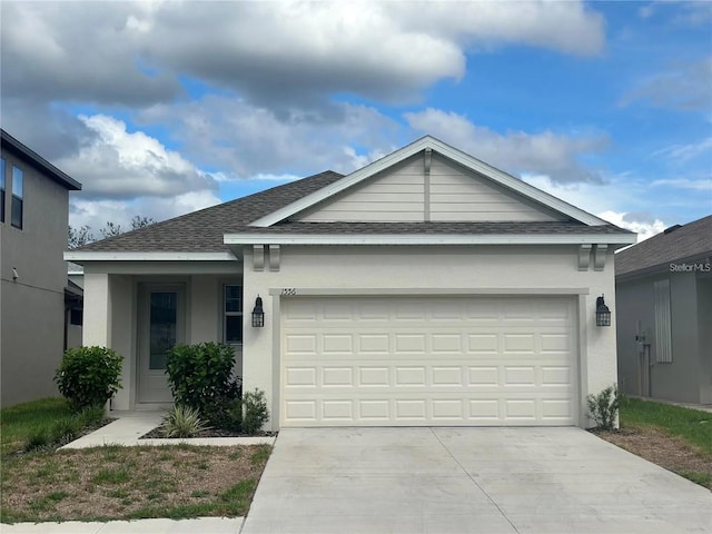 ranch-style house featuring a garage, concrete driveway, and stucco siding