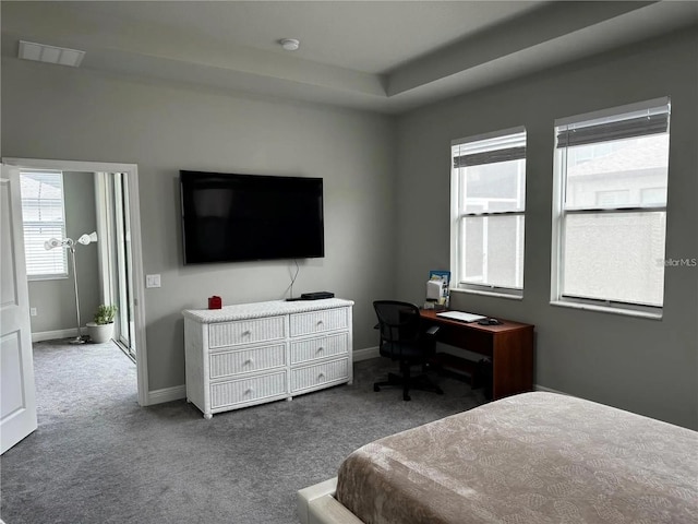 bedroom with dark colored carpet, visible vents, and baseboards