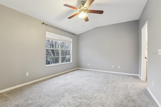 unfurnished room featuring vaulted ceiling, baseboards, a ceiling fan, and light colored carpet