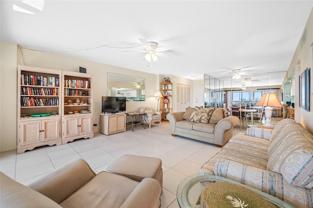 living room with a ceiling fan, light tile patterned flooring, and visible vents