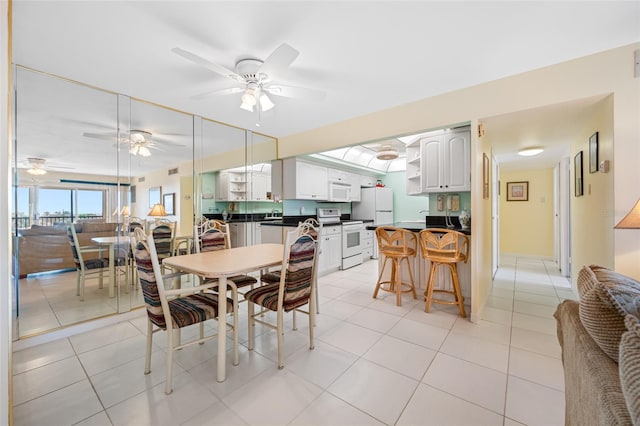 dining room with visible vents, light tile patterned flooring, and a ceiling fan