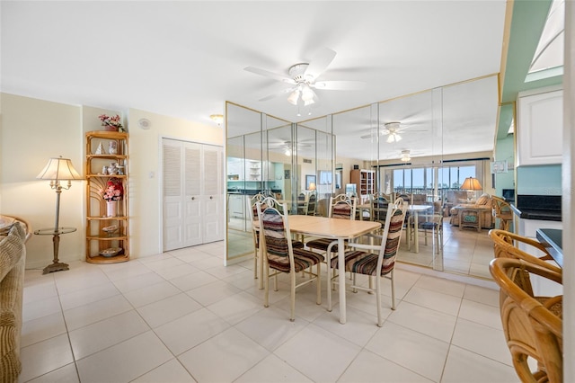 dining space with light tile patterned floors and a ceiling fan