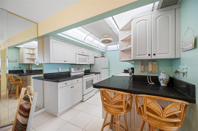 kitchen featuring white appliances, a skylight, open shelves, and a sink