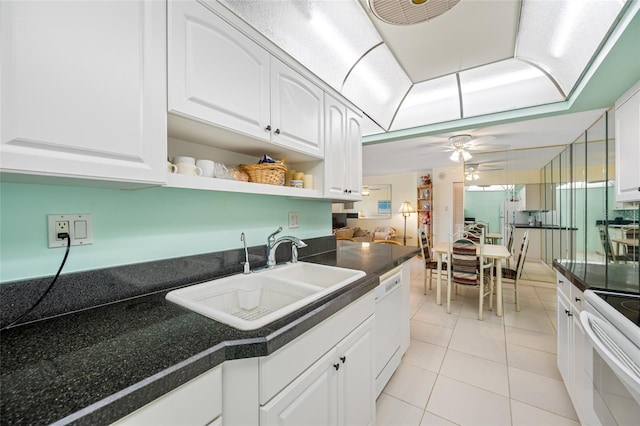 kitchen with white appliances, dark countertops, white cabinetry, open shelves, and a sink