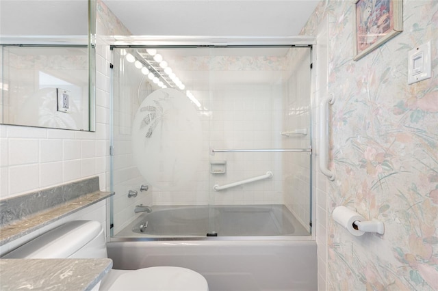 bathroom with bath / shower combo with glass door, vanity, and toilet