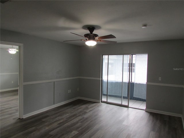 empty room featuring dark wood-style floors, ceiling fan, and baseboards