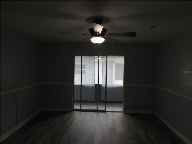 spare room featuring ceiling fan, baseboards, and wood finished floors