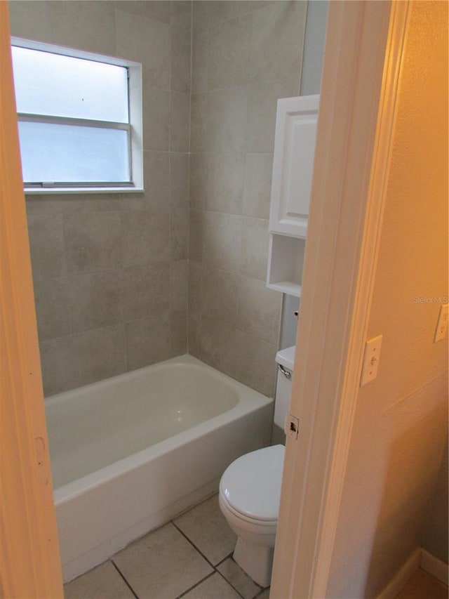 bathroom featuring shower / washtub combination, toilet, and tile patterned floors