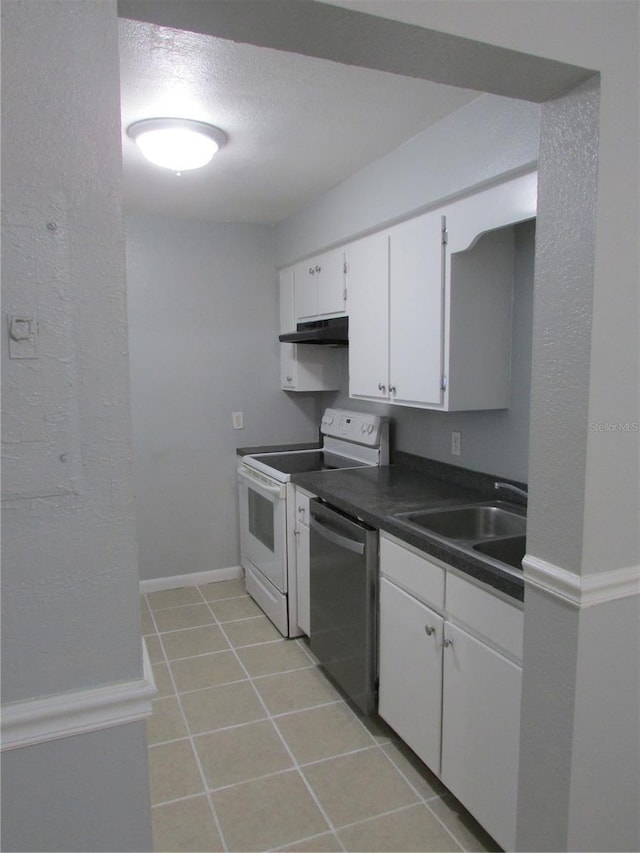 kitchen with dark countertops, white cabinets, a sink, dishwasher, and under cabinet range hood