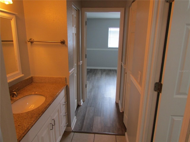 bathroom featuring tile patterned floors, baseboards, and vanity