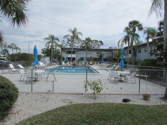 pool featuring fence and a patio