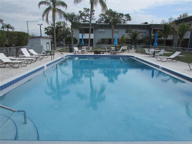 pool featuring a patio and fence