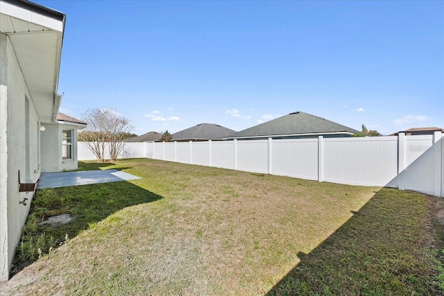 view of yard featuring a patio area and a fenced backyard