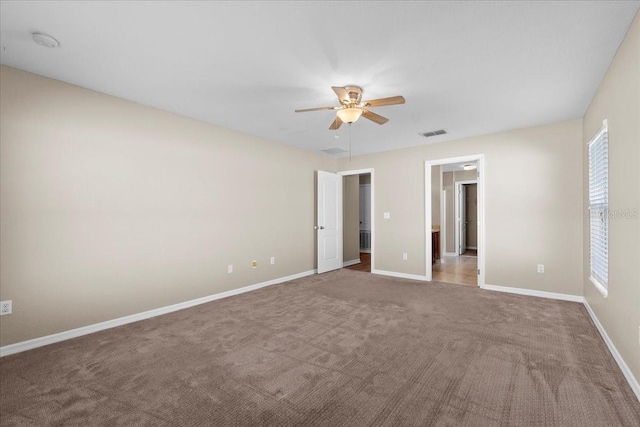 unfurnished bedroom featuring ceiling fan, carpet, visible vents, and baseboards