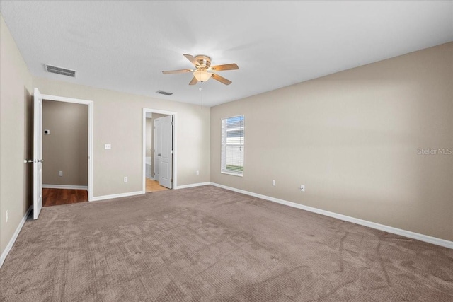 unfurnished bedroom with a ceiling fan, carpet, visible vents, and baseboards