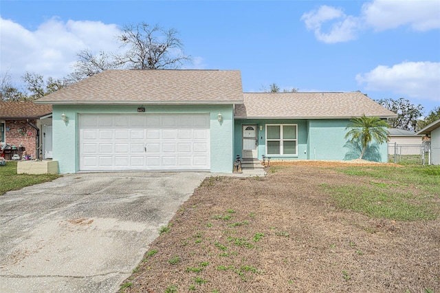 ranch-style home with a garage, driveway, roof with shingles, and stucco siding