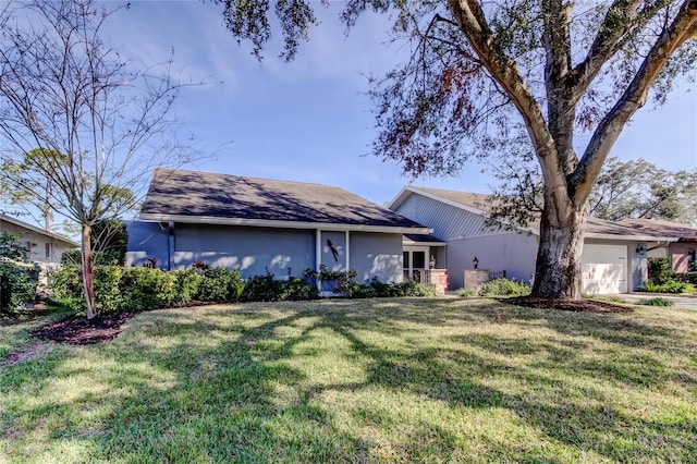 single story home featuring an attached garage, a front lawn, and stucco siding