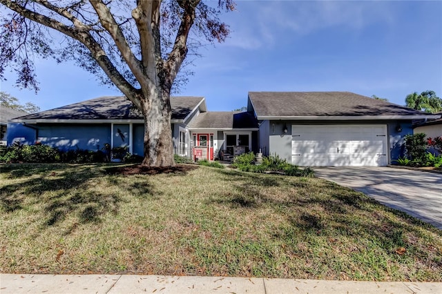 single story home with a garage, concrete driveway, a front lawn, and stucco siding