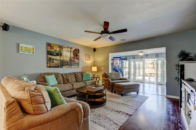 living room featuring wood finished floors and a ceiling fan