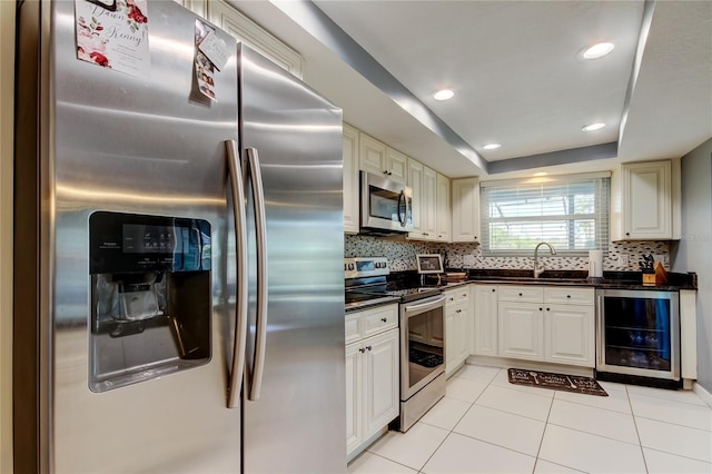 kitchen featuring dark countertops, wine cooler, a sink, stainless steel appliances, and backsplash