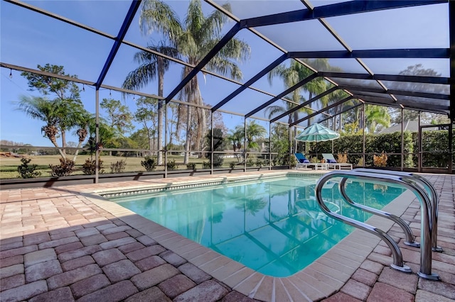 outdoor pool featuring a patio area and glass enclosure