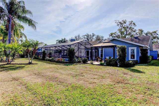 view of front of house with a front lawn, a lanai, and a gazebo