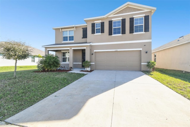 traditional-style home with an attached garage, concrete driveway, a front yard, and stucco siding