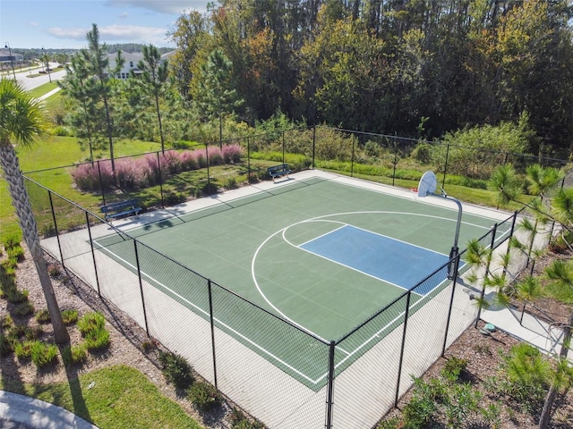 view of basketball court featuring community basketball court and fence